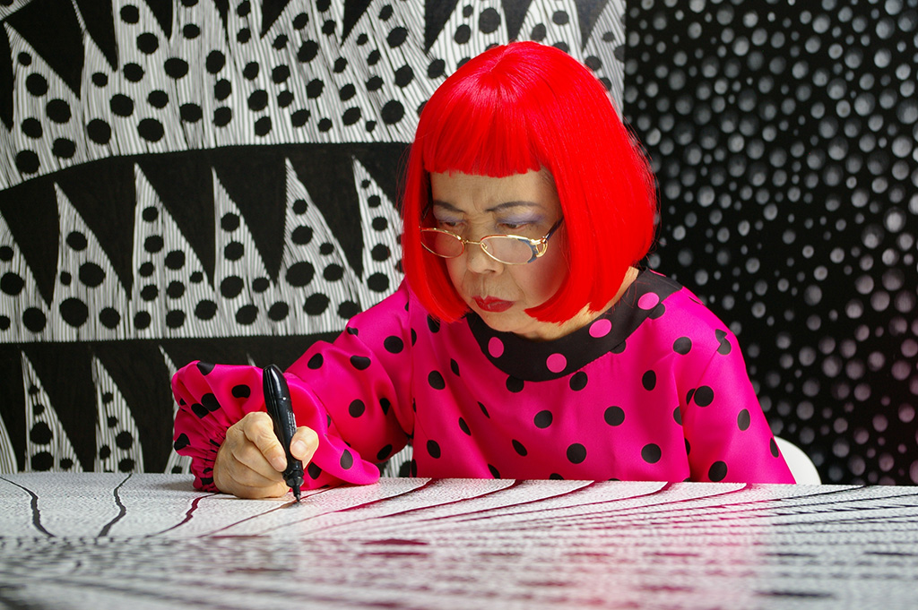 Artist Yayoi Kusama drawing in KUSAMA -INFINITY. © Tokyo Lee Productions, Inc. Courtesy of Magnolia Pictures.